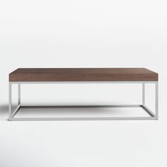 a wooden and metal coffee table on a white background