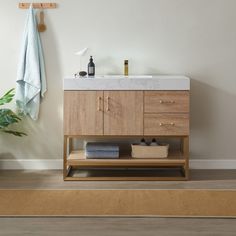 a bathroom with a sink, towel rack and rug on the floor in front of it