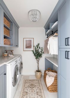 a washer and dryer in a laundry room next to a rug on the floor