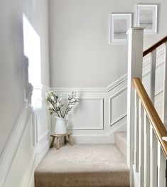 there is a vase with flowers on the stairs