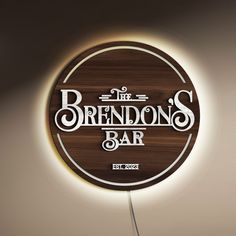 a wooden sign that says the brendons bar on it's side with a light above it