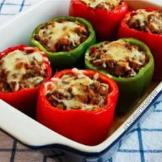 several stuffed peppers in a white casserole dish