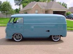 a blue van parked in front of a house