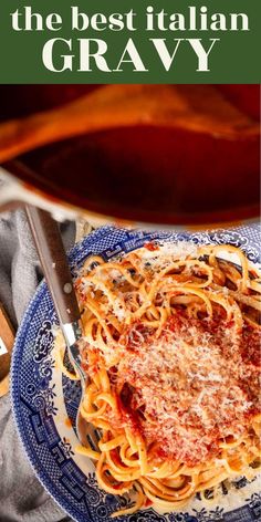 the best italian gravy is served on a blue and white plate with silverware