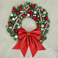 a christmas wreath with candy canes and ornaments