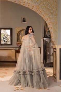 Step into the spotlight with this stunning Grey Georgette Net Embroidered Lehenga Set by Suruchi Parakh. Crafted from premium quality georgette and net fabrics, this set is perfect for any special occasion.
The gorgeous grey lehenga features intricate sequins embroidery that sparkles with every step you take, adding a touch of glamour to your look. The matching blouse perfectly complements the lehenga, and together they create a sophisticated and elegant outfit.
But the real showstopper is the c Fitted Net Gown With Resham Embroidery, Party Wear Gown With Intricate Embroidery On Net, Semi-stitched Net Party Gown, Anarkali Sets For Reception In Net, Wedding Party Wear Georgette Sets, Georgette Wedding Party Wear Set, Net Dupatta Sets For Reception, Floor-length Net Sets With Intricate Embroidery, Reception Net Sets With Dupatta