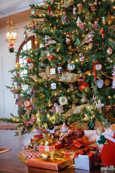 a decorated christmas tree with presents under it