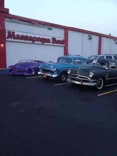 several classic cars parked in front of a building