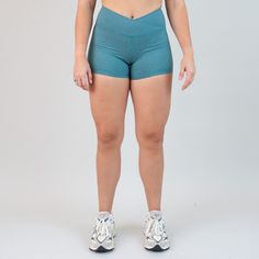 Discover our V Waistband shorts, featuring a 3.5” inseam for all-day comfort and versatility. The unique criss-cross waistband not only adds flair but also ensures a secure and flattering fit, making them perfect for every day wear. The "goes with everything" neutral shade of heather teal you didn't know you needed. Neutral enough to pair with any color, yet balanced with enough color that your friend is sure to ask you about them and snag a matching pair. Super high rise 3.5" inseam Cross front High-waisted Athletic Shorts With 4-way Stretch And Built-in Shorts, High Waist 4-way Stretch Yoga Shorts, Solid Color High-waisted Activewear Shorts With 4-way Stretch, Solid High-waisted Moisture-wicking Activewear Shorts, Stretch 2-in-1 Athletic Shorts With Breathable Fabric, Muscle Tanks, Leggings Shop, Jet Set, Racerback Tank