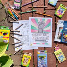 several books and pencils laid out on the ground next to each other with colored pencils