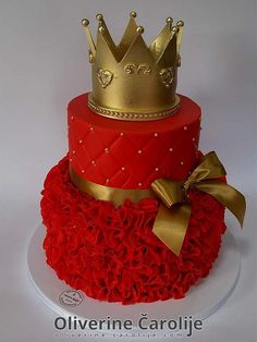 a red and gold cake with a crown on top