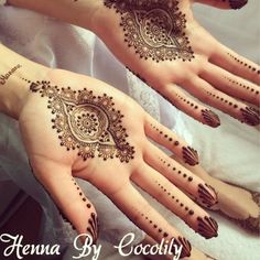 two hands with henna designs on them