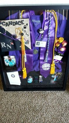 a display case filled with purple and yellow graduation caps, tassels, and other items