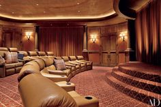 a home theater with brown leather seats