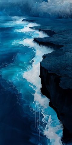 an image of the ocean with waves coming in from the water and clouds above it