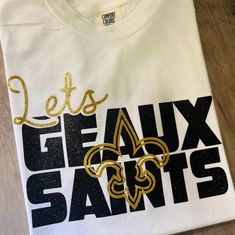 Choose Your Shirt Brand before abdding to Cart. Available in Gildan brand & Comfort colors. Both 100% Cotton and and unisex in sizing. Thank You for visiting my Shop New Orleans Saints Women Shirts, White Glitter Print Crew Neck Top, Game Day Glitter Print Crew Neck T-shirt, White Glitter Print Short Sleeve T-shirt, Team Spirit Glitter Print Crew Neck T-shirt, Team Spirit Crew Neck T-shirt With Glitter Print, Crew Neck T-shirt With Glitter Print For Team Spirit, Saints Tshirt, New Orleans Saints Shirts