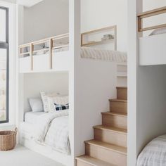 a bedroom with bunk beds and stairs leading up to the second floor bed in front of a window