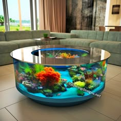 a fish tank in the middle of a living room with couches and tables around it