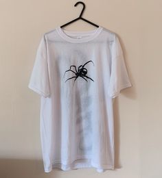 "Casual & comfy oversized tee with a unique hand drawn design  🕷️ The design has been drawn using fabric paint & will not fade or run when washed! Message me on insta for commissions @marikocustoms ❤️🔥 The top is a size large, seen on a size 8 - 10, 5\"5." Casual Hand Printed T-shirt For Streetwear, Artsy White Custom Print T-shirt, White Band Merch Top With Custom Artwork, White Crew Neck T-shirt With Hand Printed Details, White Hand-printed Crew Neck T-shirt, White Custom Print Grunge T-shirt, Hand Painted Cotton Graphic Tee, Hand Painted White Short Sleeve Tops, White Hand Painted Short Sleeve T-shirt