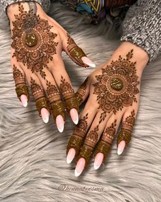 two hands with henna tattoos on them, one is brown and the other is white