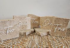 three pieces of stone with words written on them