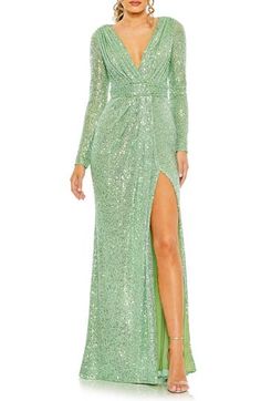 Embellished with sparkly sequins from head to toe with a tantalizing peek of skin at the neck and thigh, this long-sleeve gown channels old Hollywood glamour. 63" length (size 8) Deep V-neck Long sleeves Lined, except sleeves 100% polyester Spot clean Imported Asian Owned/Founded Fitted Floor-length Sequin Dress With Glitter, Glamorous Long Sleeve Gown For Holidays, Glamorous Long Sleeve Holiday Gown, Fitted Long Sleeve Embellished Gown, Fitted Glitter Gown For Formal Events, Long Sleeve Embellished Gown For Night Out, Formal Gown With Contrast Sequin And Long Sleeves, Long Sleeve Gala Gown For Night Out, Long Sleeve Embellished Gown For Party Season