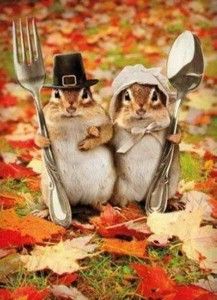 two chipmuns dressed in thanksgiving attire with forks and spoons