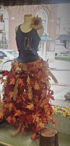 a dress made out of leaves on display