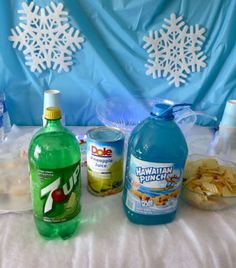 the table is set up with various drinks and snacks