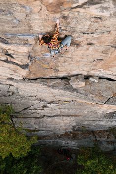 a man climbing up the side of a cliff