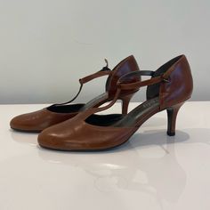 Brand New, Never Worn. Classic Brown Heels For Spring, Classic Cognac Heels For Formal Occasions, Cognac Heels For Formal Occasions, Classic Formal Heels In Cognac Color, Elegant Cognac Pointed Toe Heels, Modern Brown Heels With 4-inch Heel, Brown Calf Leather Heels With 4-inch Heel, Brown Ankle-high Heels With Sculpted Heel, Brown Party Heels With 4-inch Heel