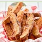 there is a basket full of fried food on the table with pink and white checkered cloth