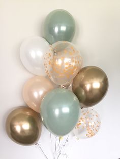 a bunch of balloons with gold confetti on them