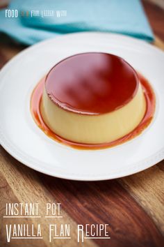 a white plate topped with a dessert covered in sauce on top of a wooden table