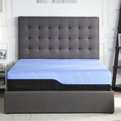 a bed with a blue mattress on it in a room next to a book shelf