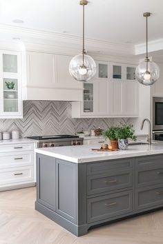 a kitchen with white cabinets and gray island