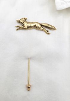 This beautiful 24K gold plated fox stick pin works wonderfully on your lapel, jacket or sweater. Woodland accessory from days gone by.  Perfect for your wedding party.  Contact me for larger quantities. Stick pin measures 3 inches long.  Fox is 2 inches wide. This piece can be used as a lapel pin for men or a stick pin for women.  Choose from the drop-down how you would like yours packaged.   Your order will be shipped in 2-3 business days.  Every piece is handcrafted in my home jewelry studio a Luxury Yellow Gold Lapel Pin Gift, Luxury Gold Brooch Lapel Pin, Fox Brooch, Fox Wedding, Fox Pendant Necklace, Gold Fox, Gift Box For Men, Foxes Necklace, Lapel Flower