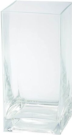 a clear square vase sitting on top of a white table