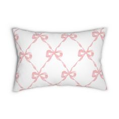 a white pillow with pink bows on it