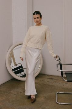 The Valeria Skirt is a satin maxi skirt. It features a bias cut and mermaid line enhancing the silhouette, while the elastic waistband provides a comfortable fit. 100% Polyester Cream Outfits, Satin Maxi Skirt, Cropped Crewneck, Sweater Crop, Elegant Blouses, Satin Maxi, Sweater Skirt, Formal Occasion, Crew Neck Sweater