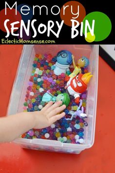 a plastic bin filled with lots of different colored buttons and small toy figures in it