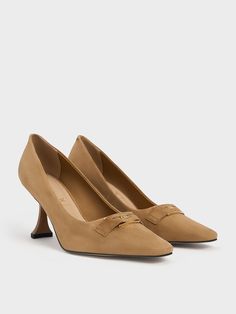 Swap your go-to black work pumps for these caramel-brown suede ones -- they'll imbue your look with a touch of tactility and a subtle pop of colour. With a modern and clean-lined silhouette, these pumps create a leg-lengthening effect that will elongate any frame. Resting on distinct sculptural heels that feature a wider base at the bottom, you can count on these pumps to elevate your stature without compromising on walkability. For added flair, these shoes also feature our signature emblem in a shiny gold-tone finish. Sculptural Heels, Work Pumps, Black Work, Caramel Brown, Charles Keith, Brown Suede, Caramel, Color Pop, Pumps