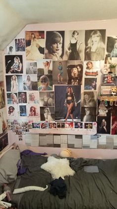 there is a bed with many pictures on the wall