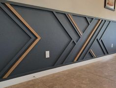 an empty room with tile flooring and wall art