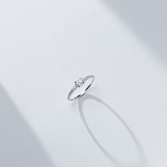 The center rose cut diamond that sits between two tapered baguettes evokes an art-deco vibe. The low profile nature of the rose cut allowed us to make an engagement ring where the diamonds all flowed into each other while hugging the finger for ultimate wearability. 14K sustainable gold Center: 0.25ct natural rose cut diamond 0.22 tcw of tapered baguette and round natural diamonds All diamonds are GH color/VS clarity Dimensions: Band Width 2.0mm taperingDelivery: This item is made to order. Plea