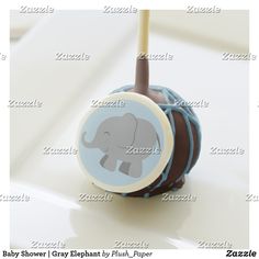 an elephant themed cake pops on a white table with a blue and brown striped background