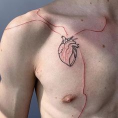 a man's chest with a red line drawn across it and a heart tattoo on his chest