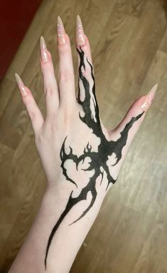 a woman's hand with black and white ink on it, showing the design