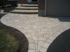 a driveway with steps leading up to the garage