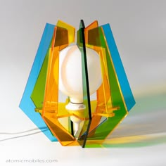 a colorful lamp with a white light bulb on it